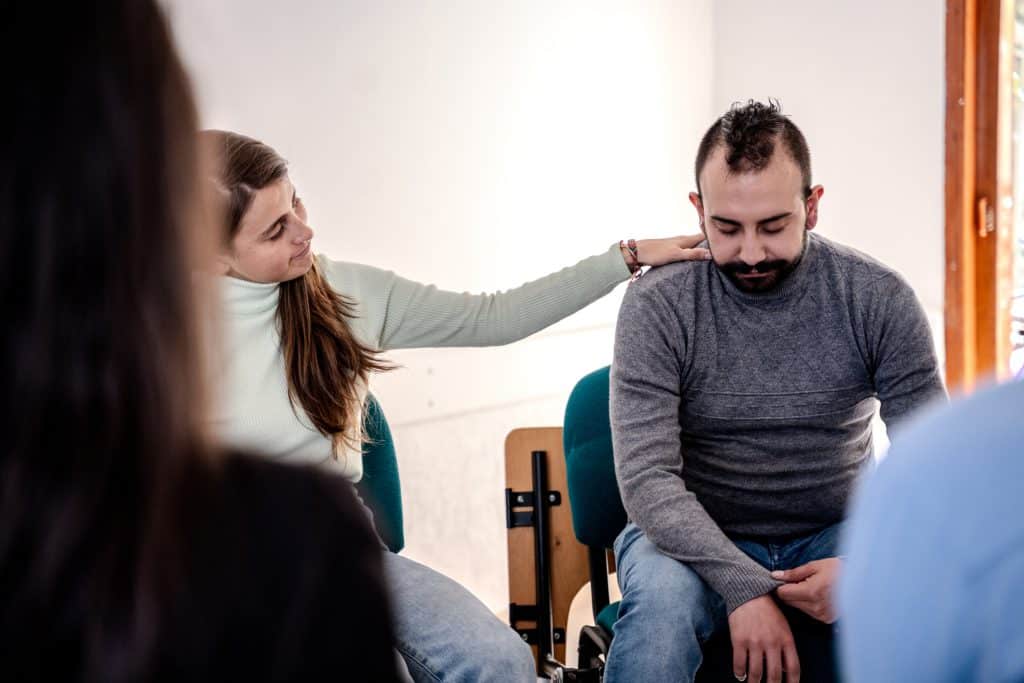 Family providing emotional support to a loved one in rehab