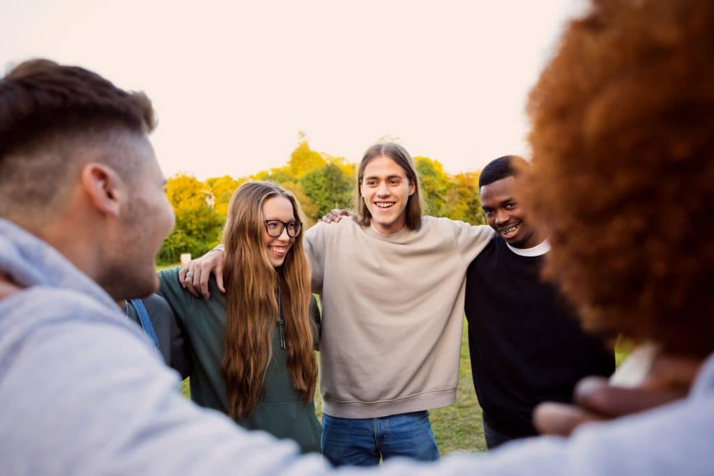 A group of friends creating a supportive atmosphere for recovery