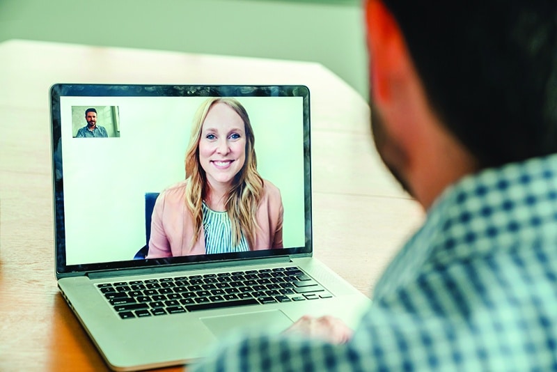 person using a laptop for a telehealth appointment - Behavioral Health